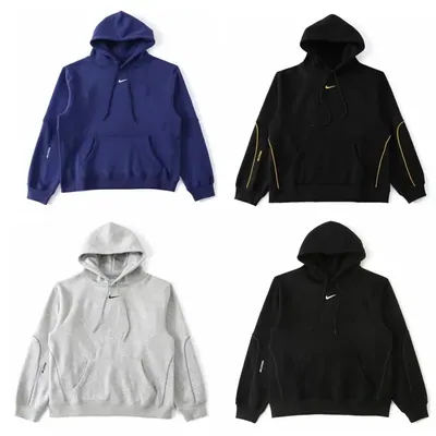 Four plain hoodies in blue, black, white and black laid flat in a two by two grid