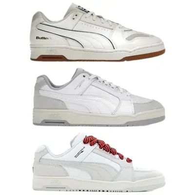 Three pairs of low-top leather sneakers in white and grey, stacked one above another