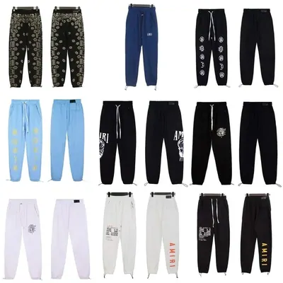 Nine pairs of printed jogger sweatpants in black, blue, light blue and white, arranged in three rows